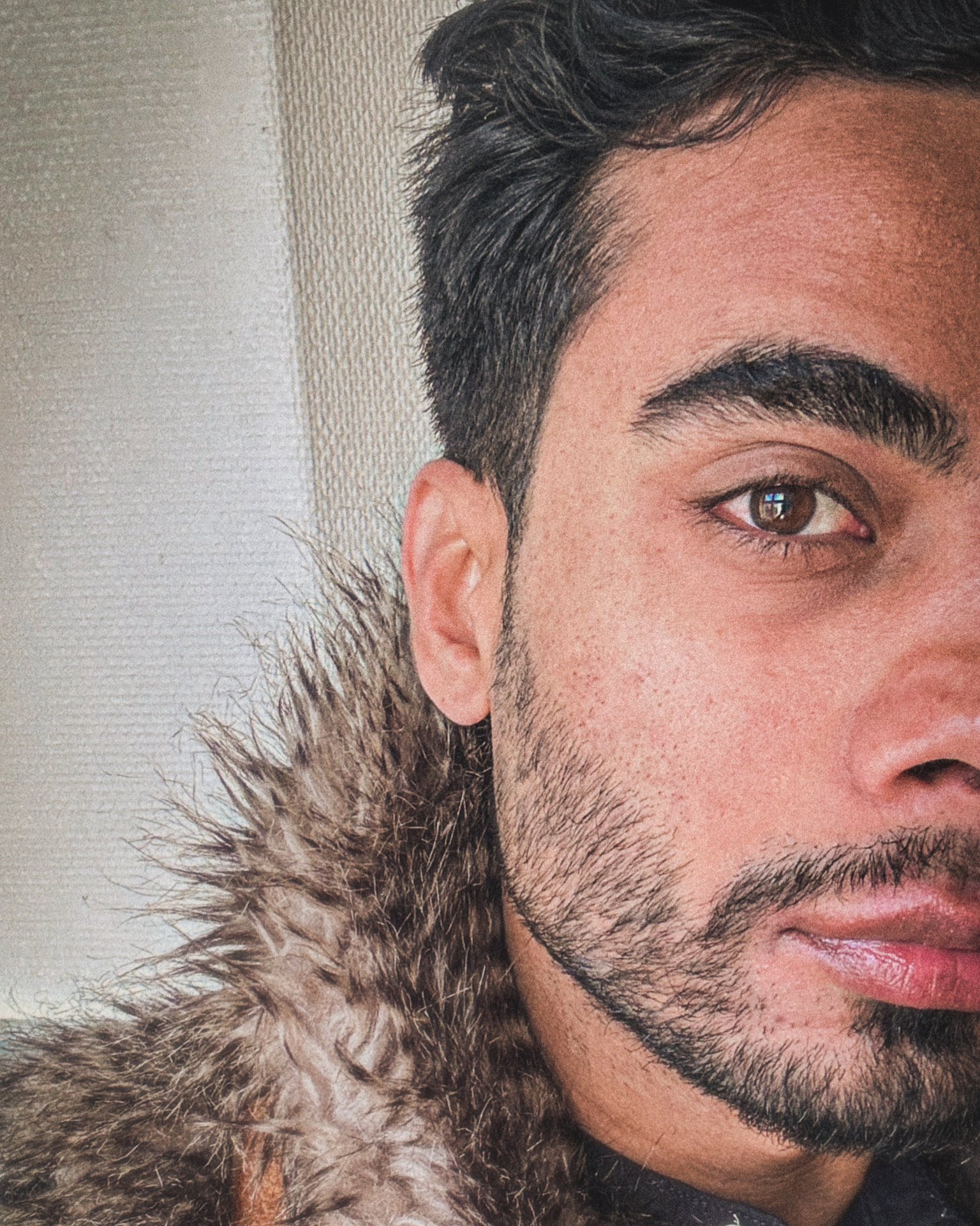 Close-up portrait of Artan Davoodi in a fur-trimmed coat